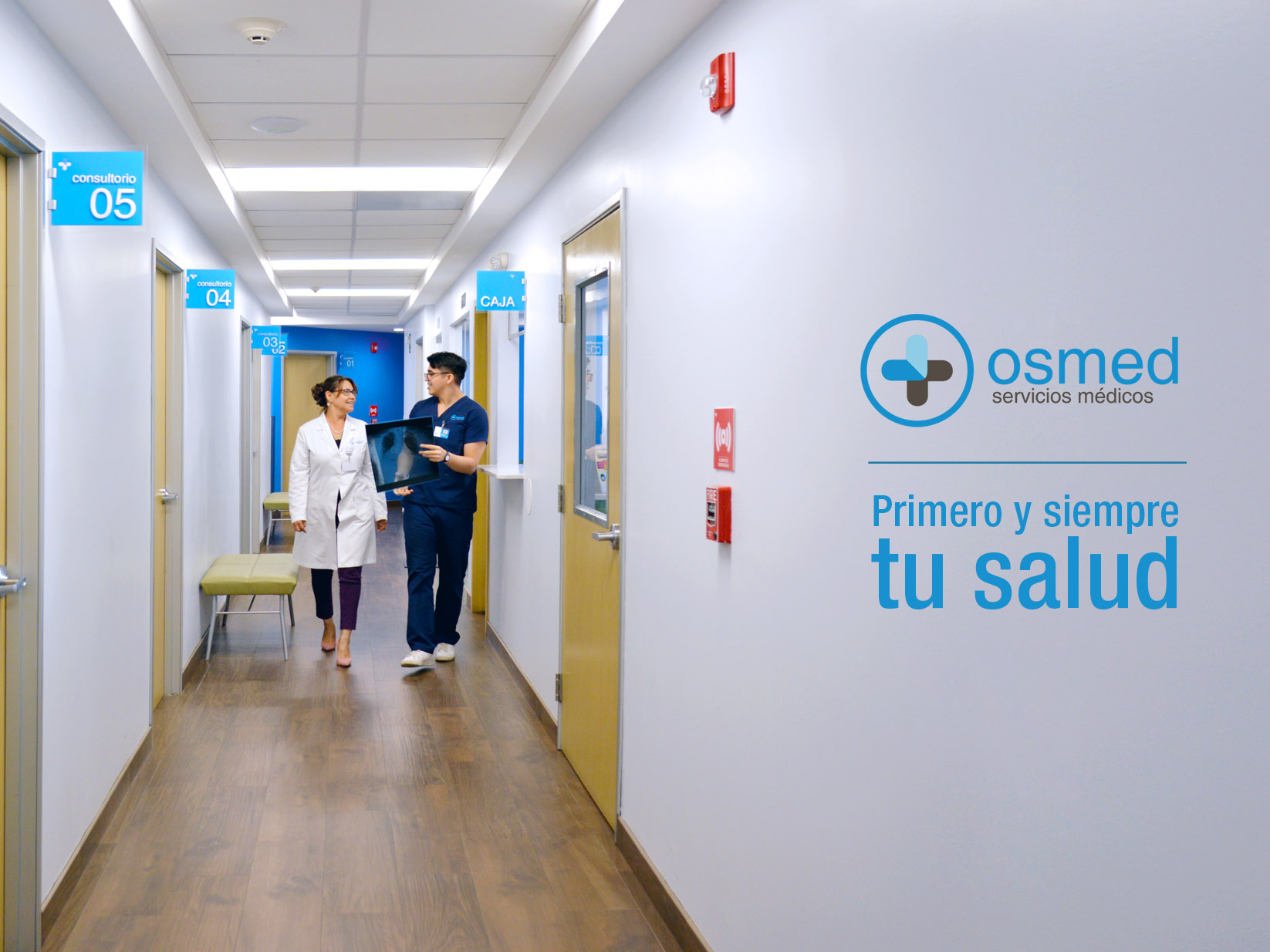 Doctor and nurse walking together in the hallway of the OSME clinic