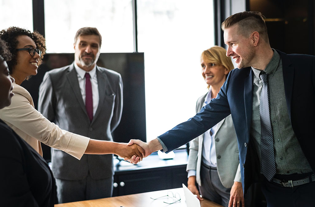 People shaking hands at a business meeting